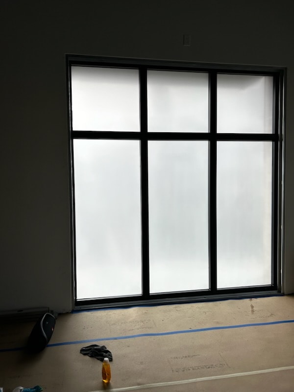 Decorative frosted film on glass shower enclosure