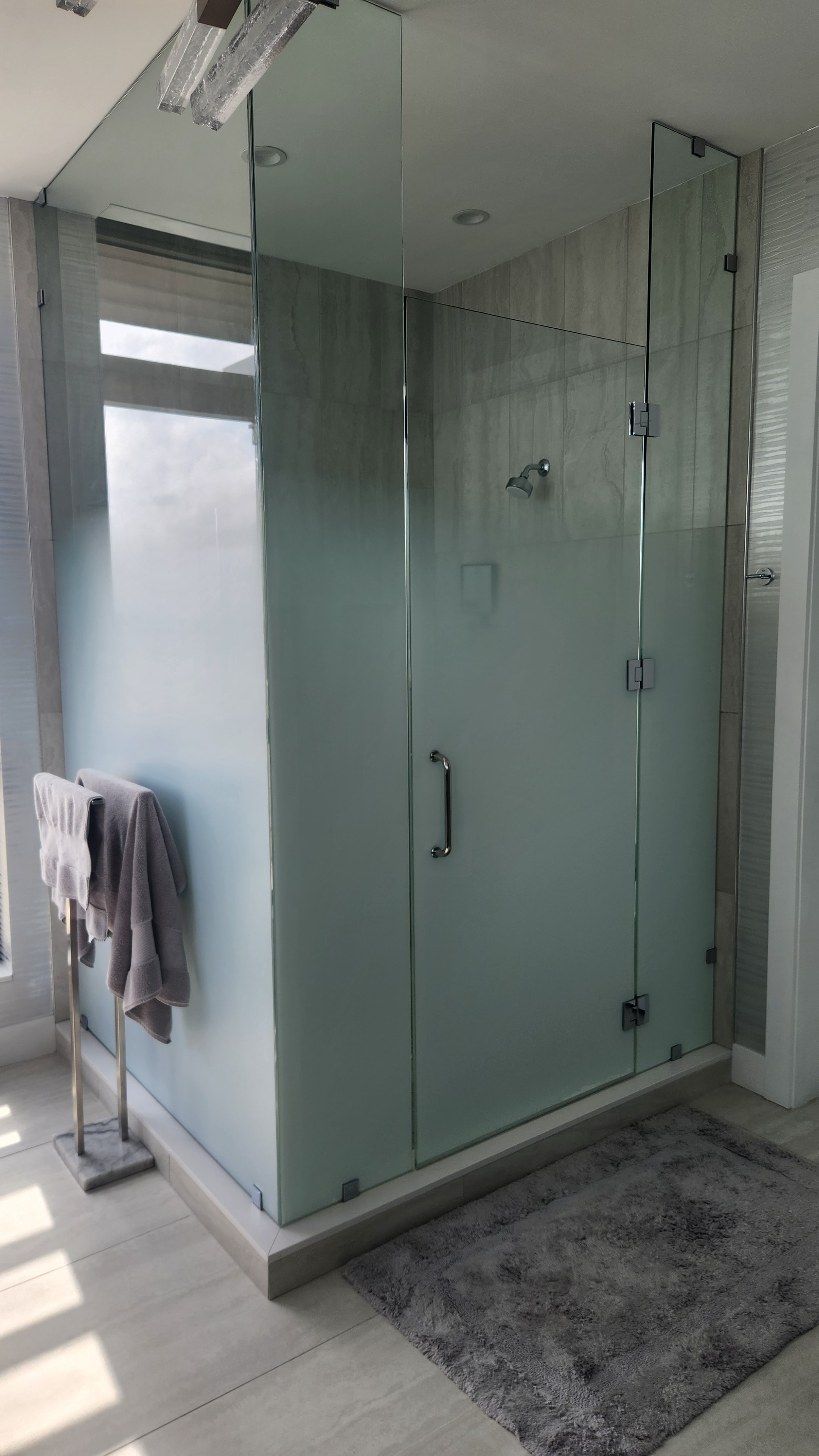 Frosted privacy window film applied to glass shower enclosure bathroom