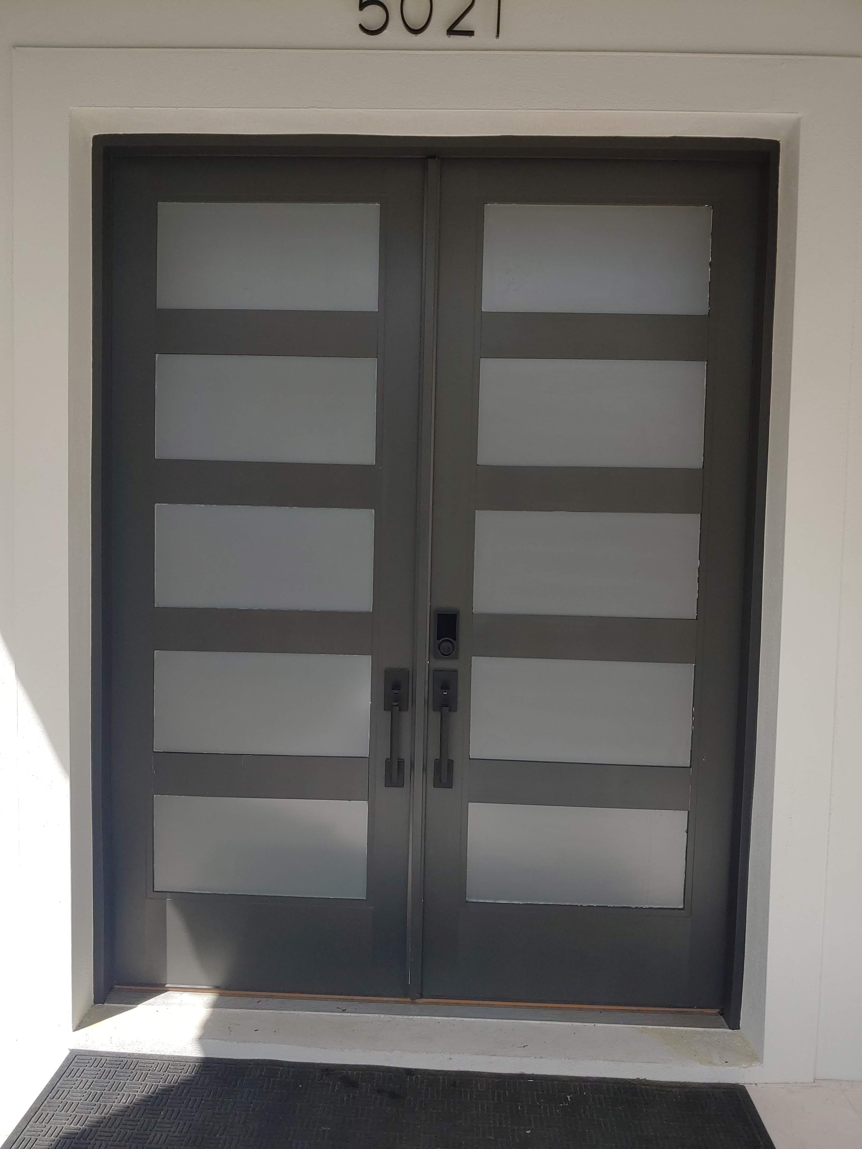 Frosted privacy film applied to residential garage door window panels